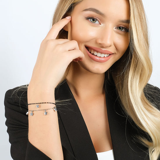 DAMENARMBAND AUS STAHL MIT STERNEN, SCHWARZEN IP-ELEMENTEN UND WEISSEM KRISTALL