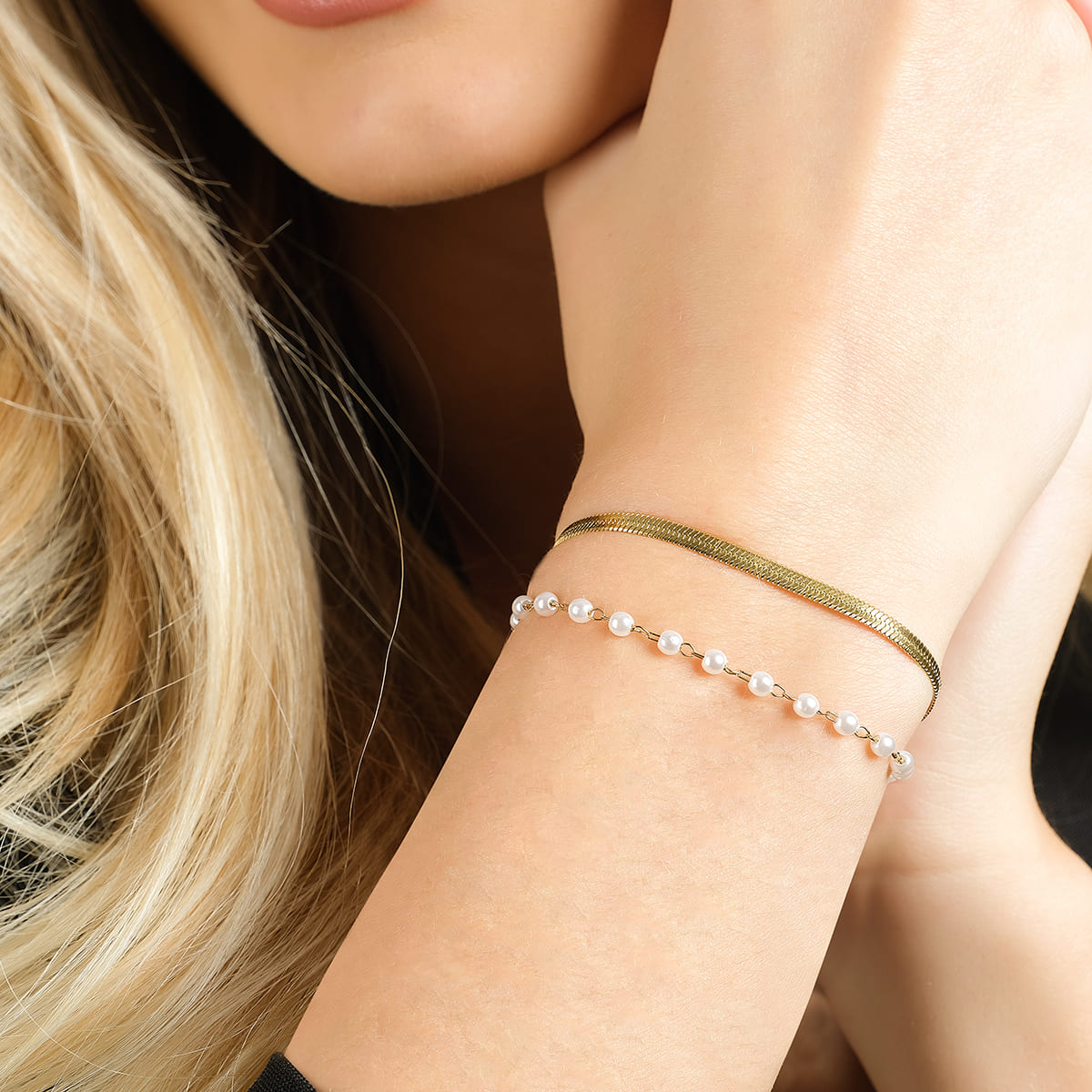 DAMENARMBAND AUS STAHL MIT WEISSEN PERLEN